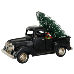 Svart lastbil i metall med en julgran på flaket