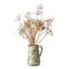 Kanna med grönt blommigt mönster